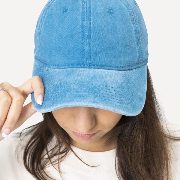 Beautiful woman in baseball cap, headband fashion studio shoot